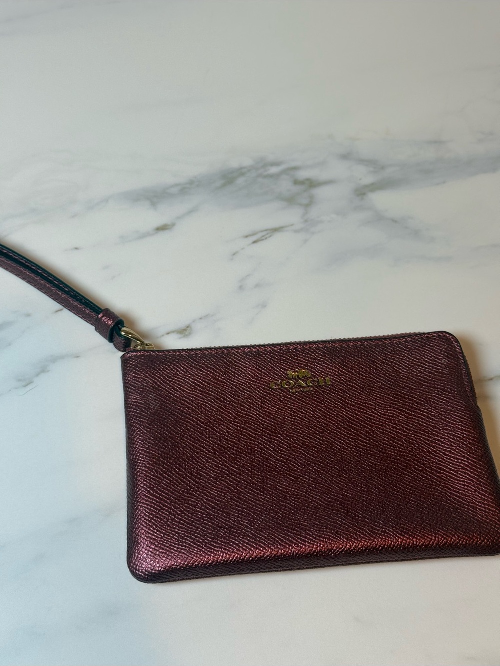 Beautiful reddish rose gold coach wristlet